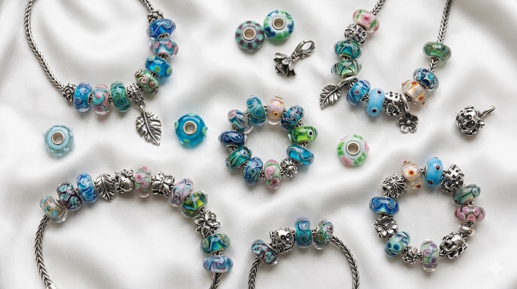 Trollbeads Murano glass beads collection display featuring jewelry pieces in ocean blue and warm gold tones