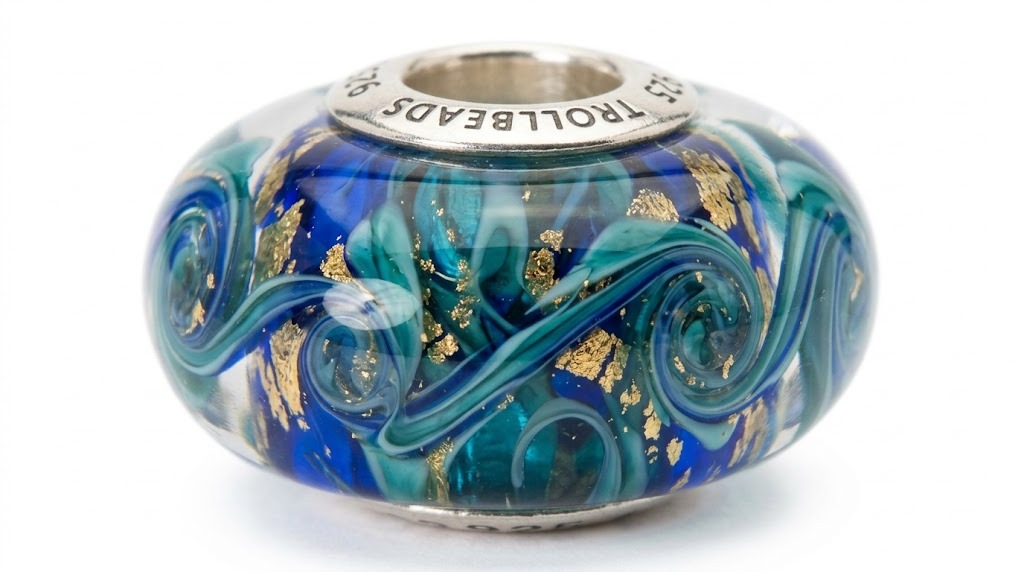 Trollbeads unique glass art collection detail view featuring handmade glass bead with colorful swirl patterns and artisan craftsmanship